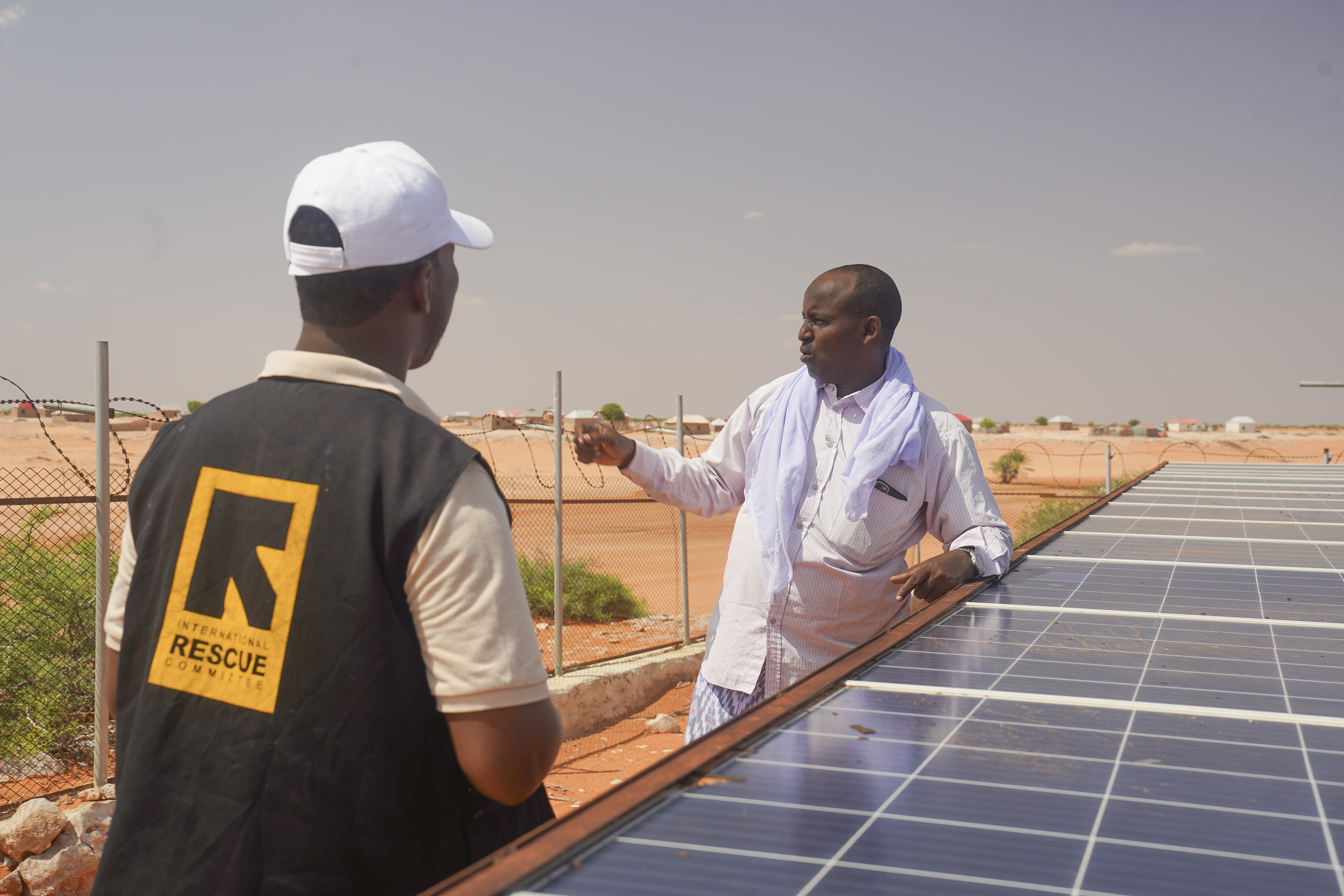 Village leader in Somalia visits solar-powered infrastructure provided through IRC.