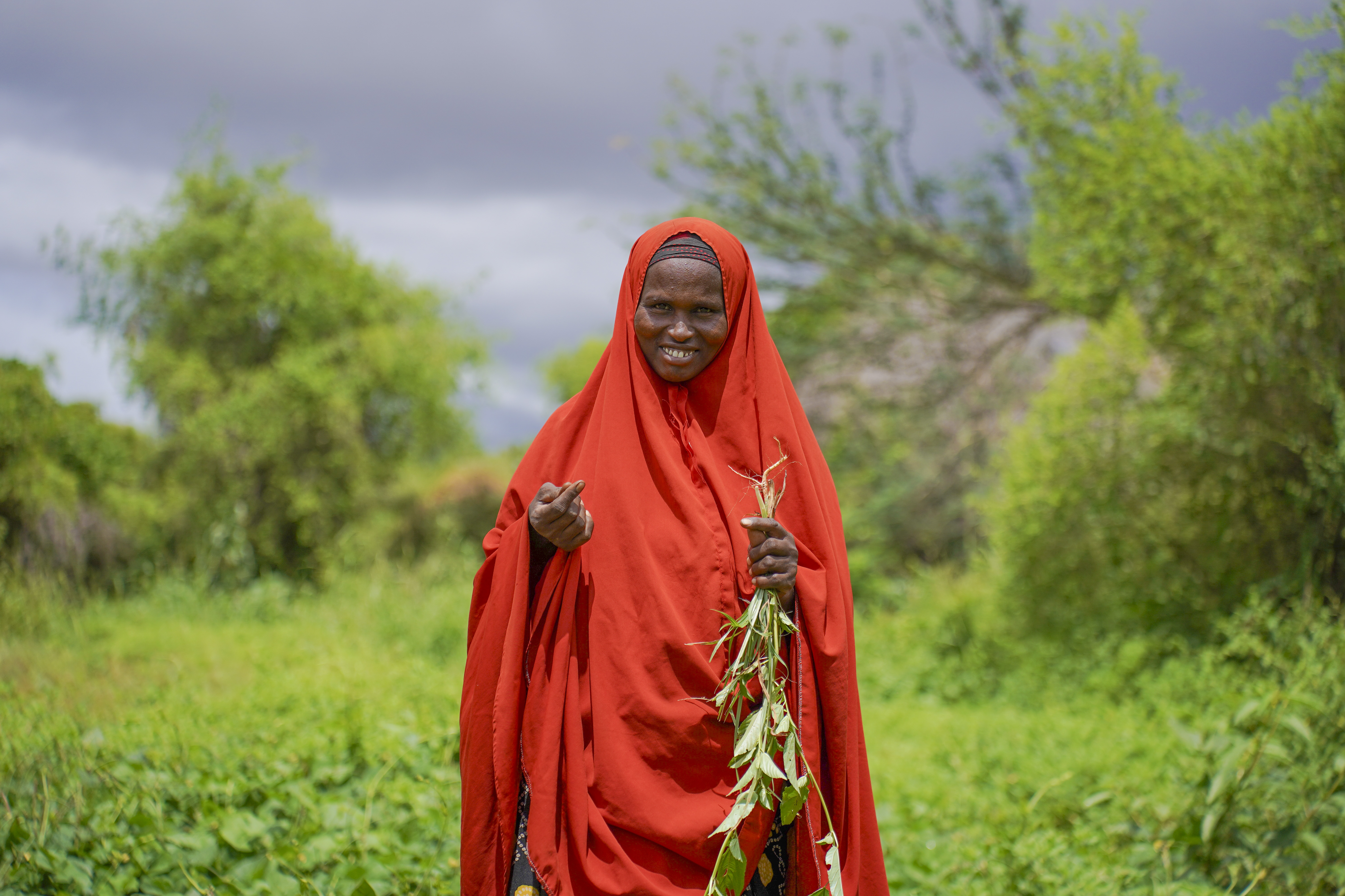 In Dinsor, Somalia, a woman stands proudly in her small farm