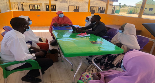 A group session of the PDIA team (Problem-Driven Iterative Adaptation) discussing and addressing issues surrounding the quality of services, in Bularafa PHCC, Yobe State